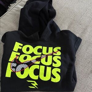Black NIKE Kids Hoodie with Neon Yellow Print. FOCUS